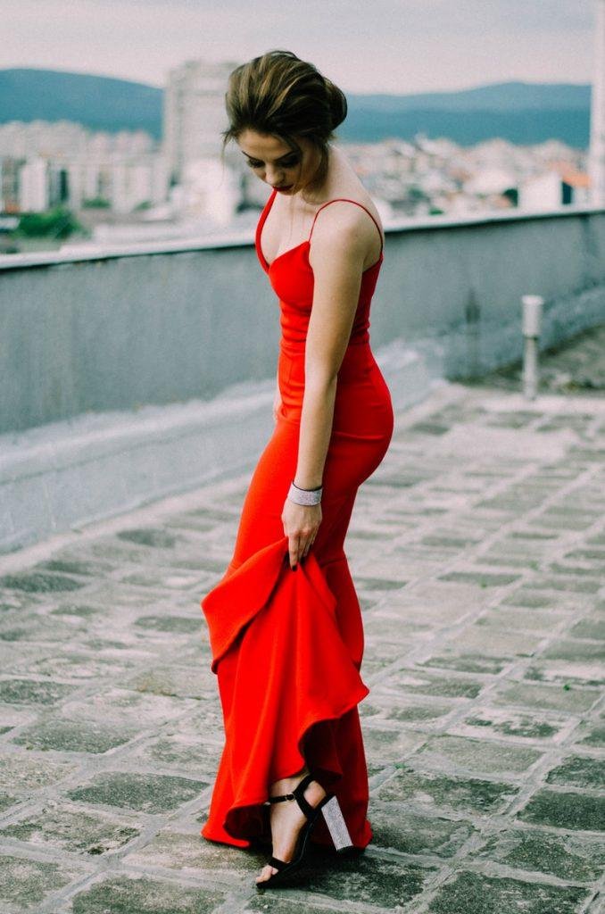woman wearing red spaghetti strap dress