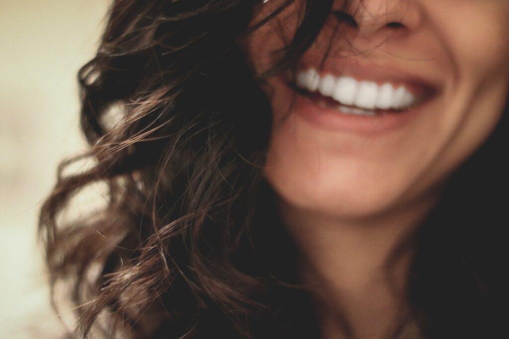 black hair women is laughing 