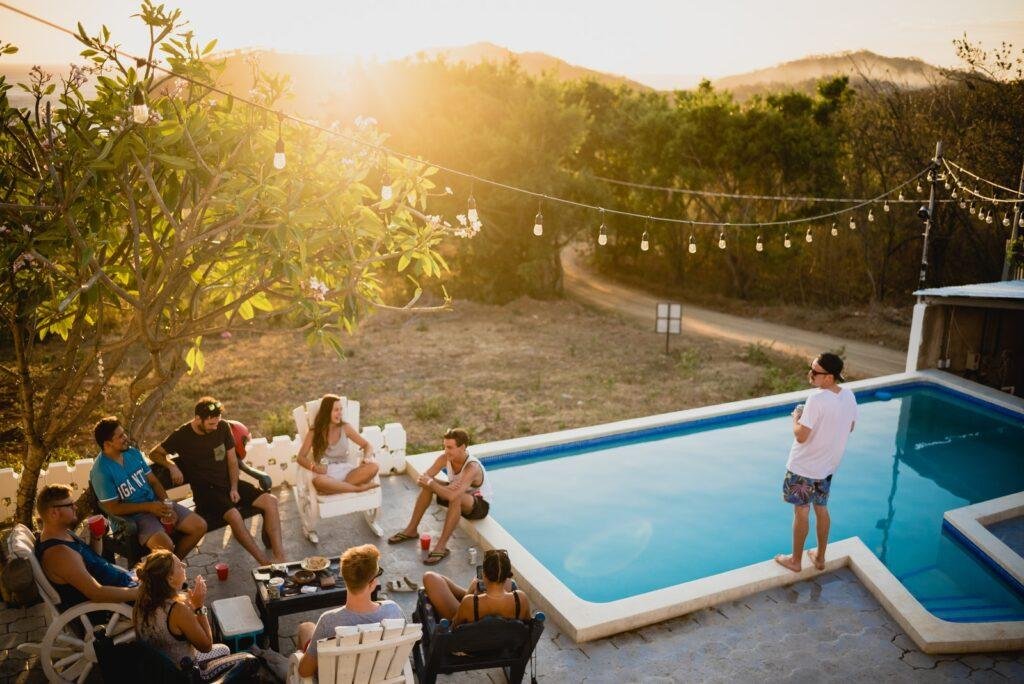 people sitting and partying on chairs near pool