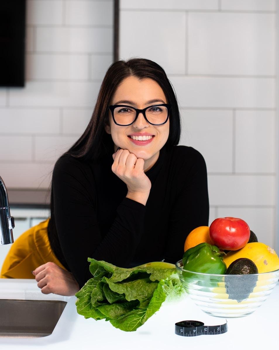 woman in black long sleeve shirt sitting on chair with healthy food and fruits
