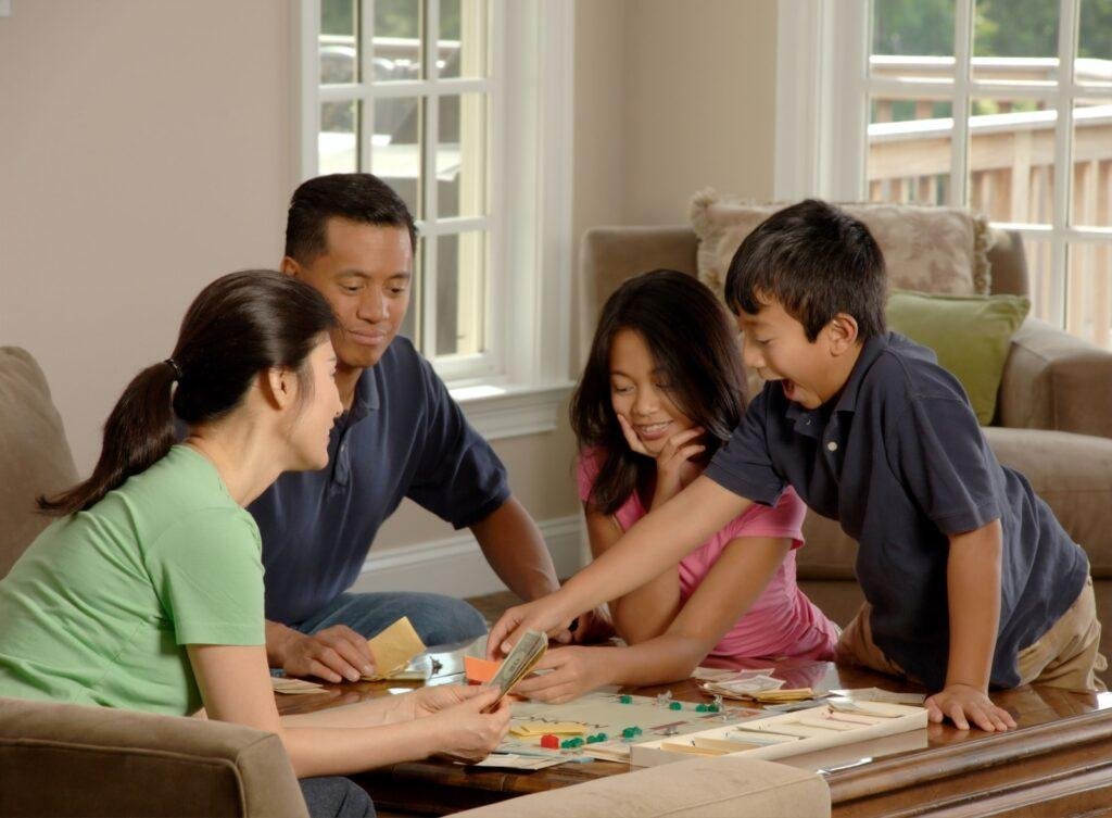 four member in family are playing game in home