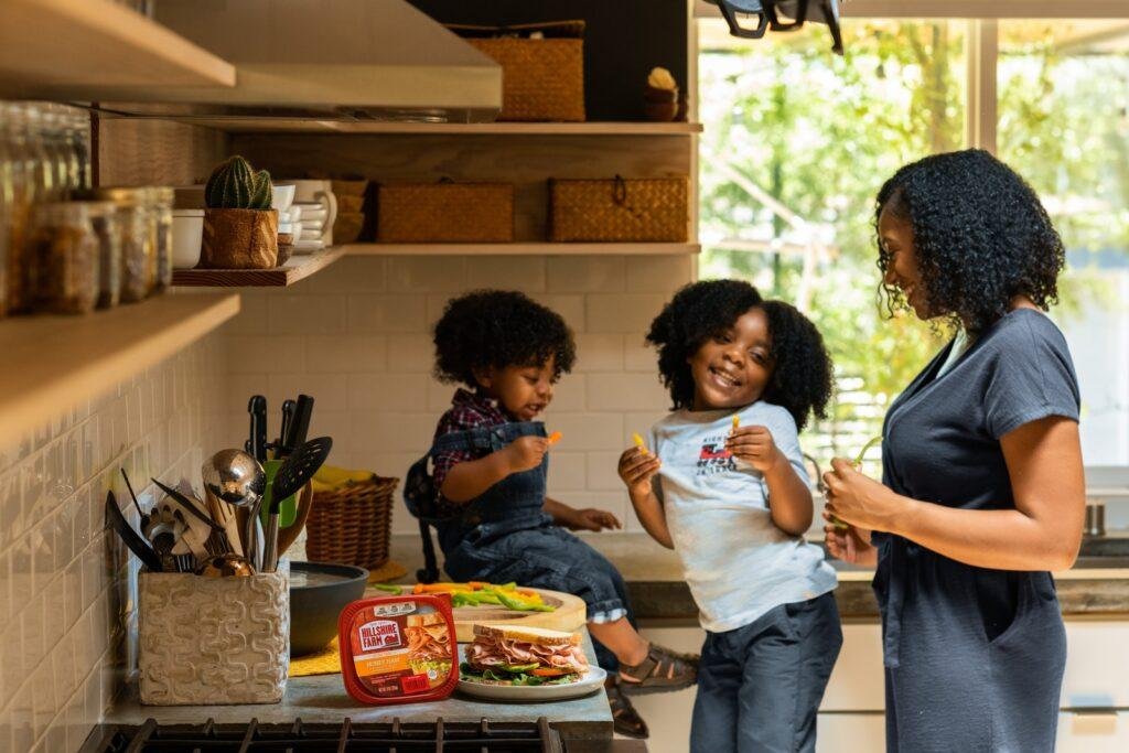a mother is talking to her two children's in kitchen