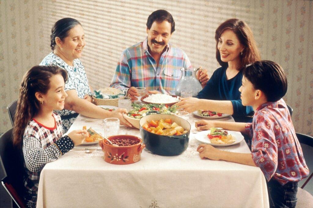 a family is eating together and creating unity between them