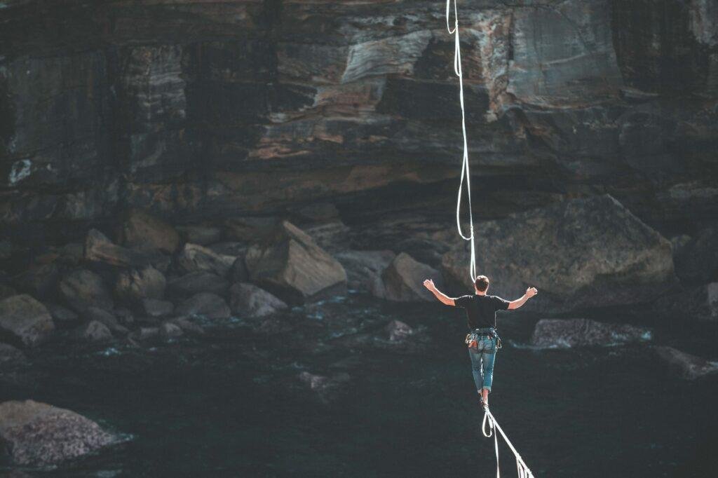 man on rope walking on mountains