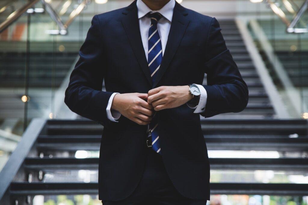 person standing by wearing coat pant