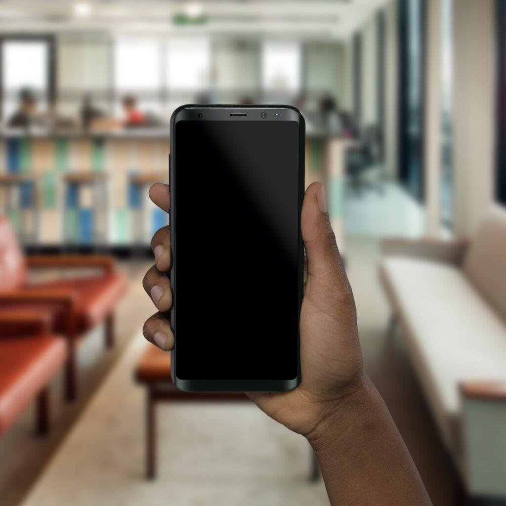 person holding black smartphone in hid hand