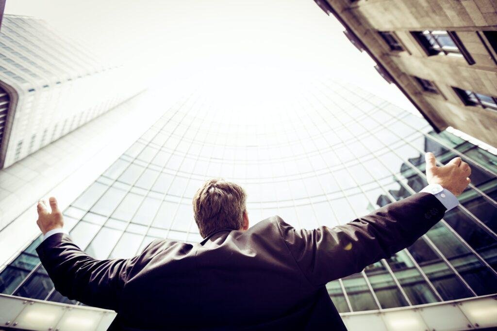 a men is standing in front of buildings