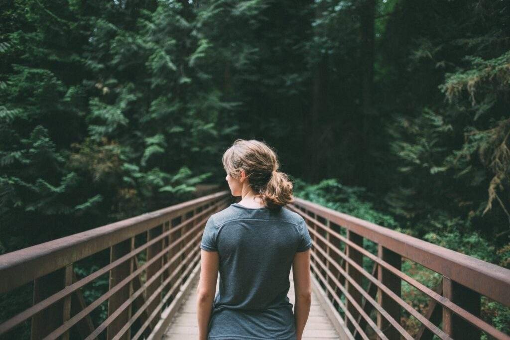 a girl is standing on bridge