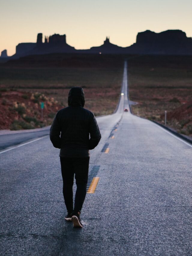 person walking in the center of the road