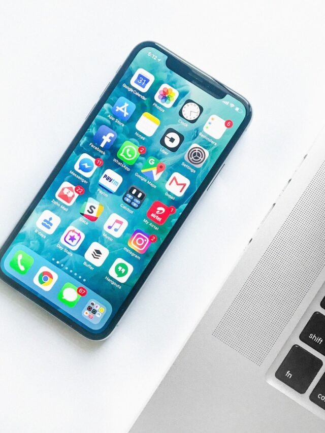white smartphone near laptop