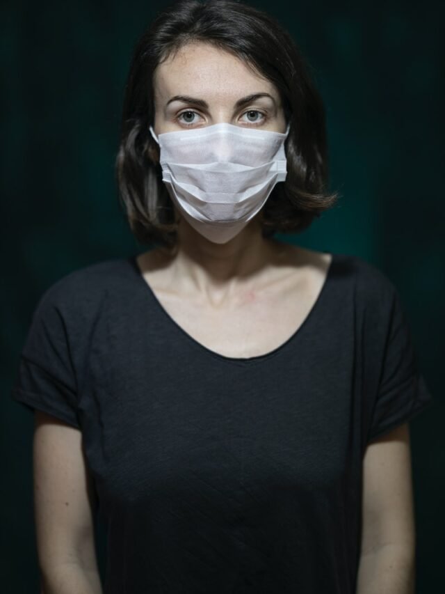 woman in black scoop neck shirt with white face mask